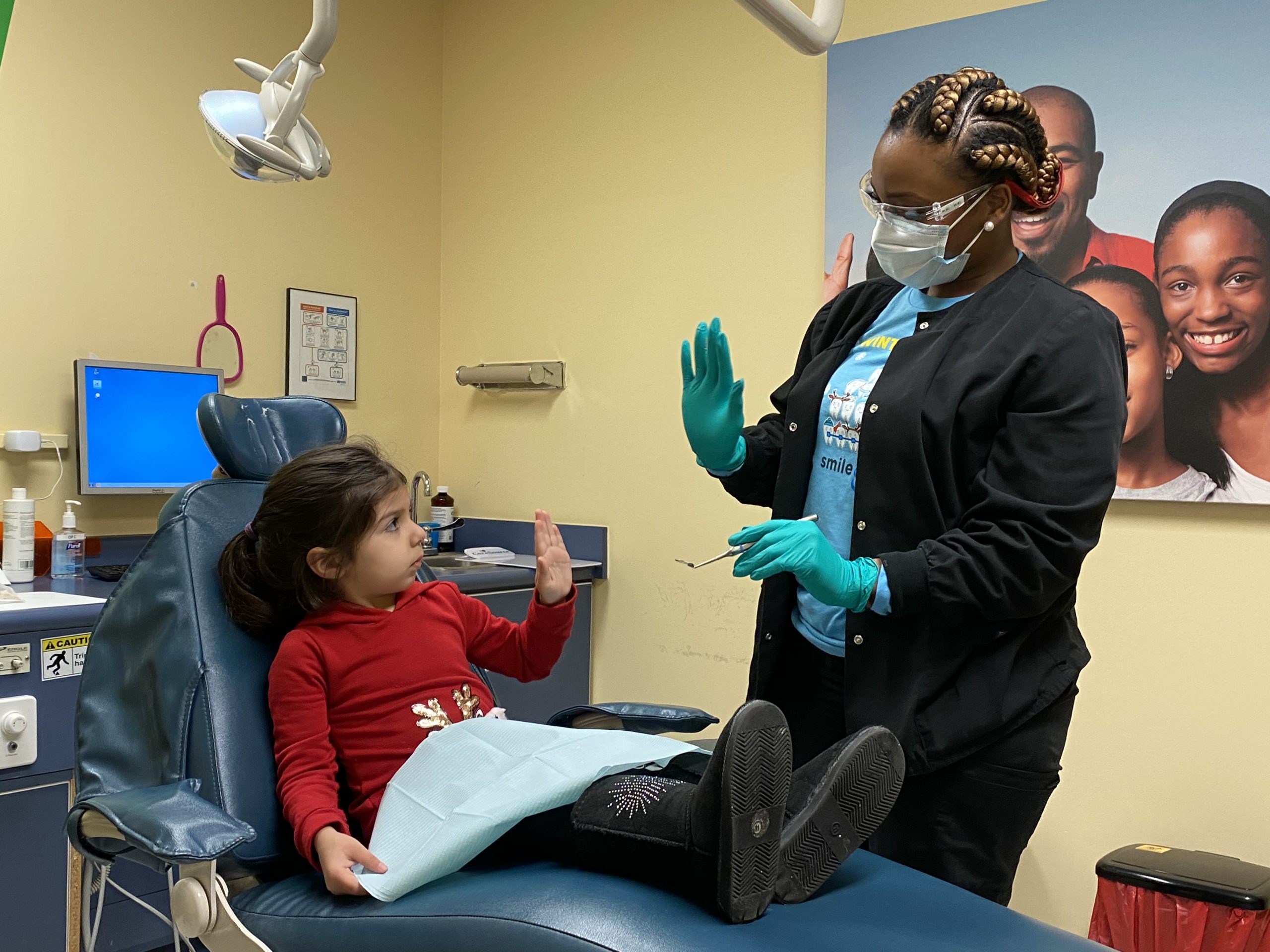 child high fives dentist